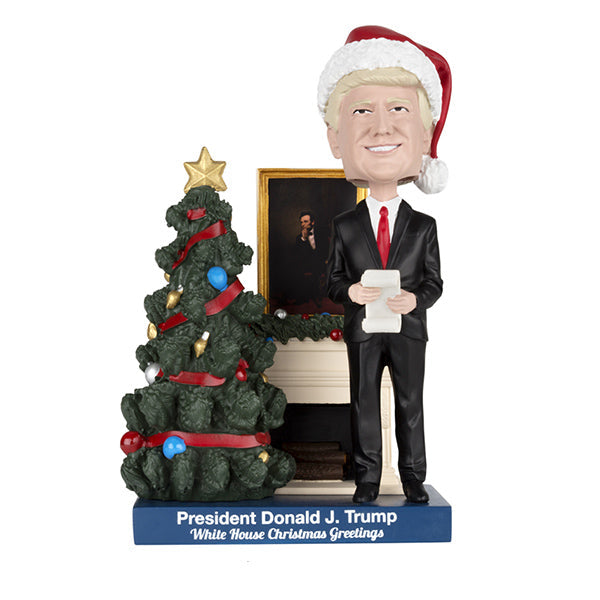 Donald Trump White House Christmas Greetings Bobblehead delicately showcasing President Trump in a festive Santa cap, surrounded by Christmas decorations.