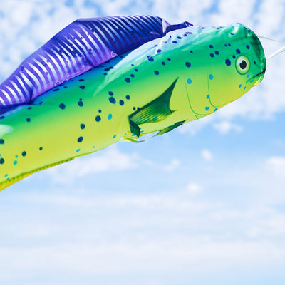 Dorado 48-Inch Fish Windsock with a colorful fish design displayed outdoors fluttering in the breeze near a boat dock.