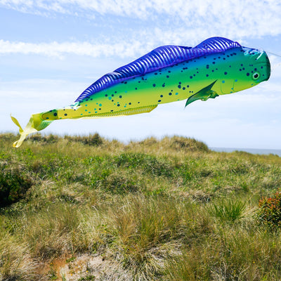Dorado 48-Inch Fish Windsock with a colorful fish design displayed outdoors fluttering in the breeze near a boat dock.