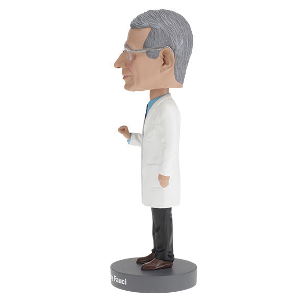 Dr. Anthony Fauci Bobblehead, over 8 inches tall, featuring detailed likeness, displayed on a desk with a vibrant box in the background.