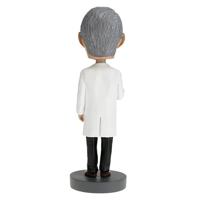 Dr. Anthony Fauci Bobblehead, over 8 inches tall, featuring detailed likeness, displayed on a desk with a vibrant box in the background.