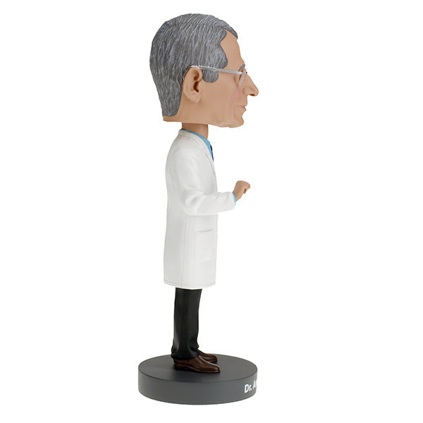 Dr. Anthony Fauci Bobblehead, over 8 inches tall, featuring detailed likeness, displayed on a desk with a vibrant box in the background.