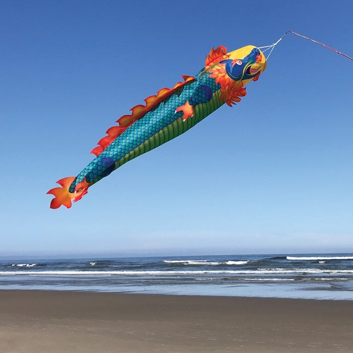 Colorful Dragon 50 inch 3D Windsock flying in the wind, showcasing vibrant dragon design in an outdoor garden setting.