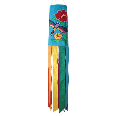 A colorful Dragonfly 40\" Windsock with appliqued graphics and fluttering tails displayed in a garden, showcasing its whimsical design.