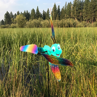 Colorful Dragonfly Baby Whirligig garden decoration with reflective mylar wings, spinning in the breeze, designed to add charm to outdoor spaces.
