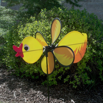 Duck Baby Spinner with bright colors and a 12-inch wheel displaying in a garden, featuring a baby duck design and fiberglass pole.