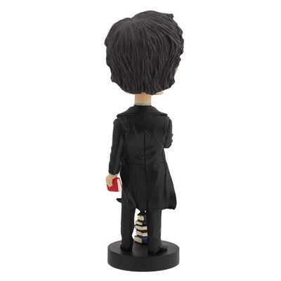 Edgar Allan Poe bobblehead standing 7 inches tall, featuring intricate details and dark attire, displayed on a desk with classic literature in the background.