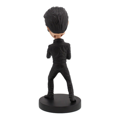 Elvis Presley '68 Comeback Special Bobblehead in black leather outfit, expertly hand-painted, displayed on a shelf against a colorful background.