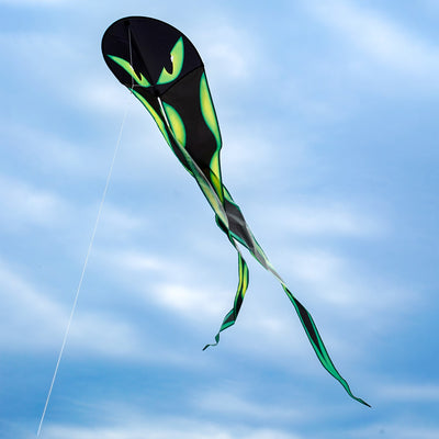 22-Inch Eyes Dancing Dragon Kite soaring in the sky with flowing tails, showcasing vibrant colors and a spooky design during outdoor play.