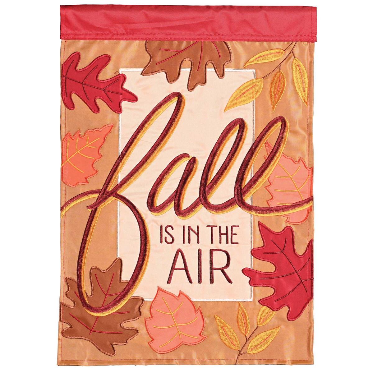 Fall Is In The Air double-sided garden flag with autumn design hanging in a garden, showcasing vibrant colors and detailed embroidery.