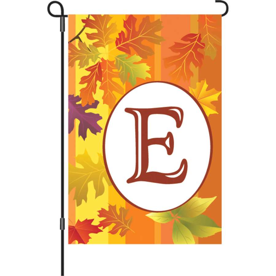 12 in. Fall Monogram Flag - E featuring vibrant autumn colors and custom monogram design displayed in a garden setting.