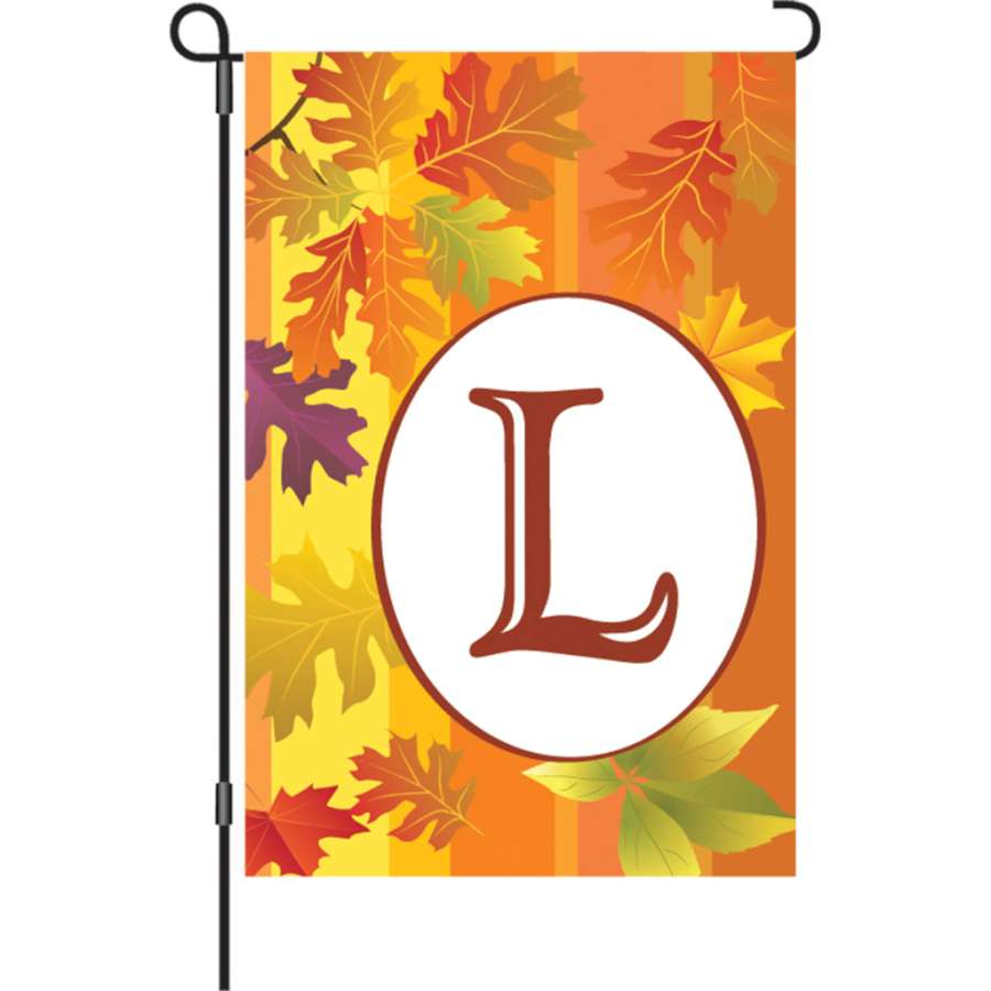 12 in. Fall Monogram Flag - L displaying a vibrant letter 'L' against warm autumn colors, showcased in a garden setting.