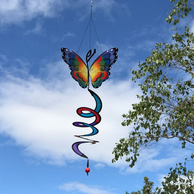 Fancy Butterfly Theme Twister featuring colorful wings that move gently in the breeze, with a vibrant curlie tail, hanging elegantly in a garden setting.