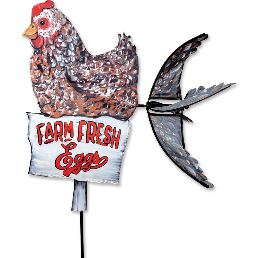 Farmhouse Chicken Spinner with colorful designs rotating in a gentle breeze, showcasing its whimsical charm in an outdoor garden setting.