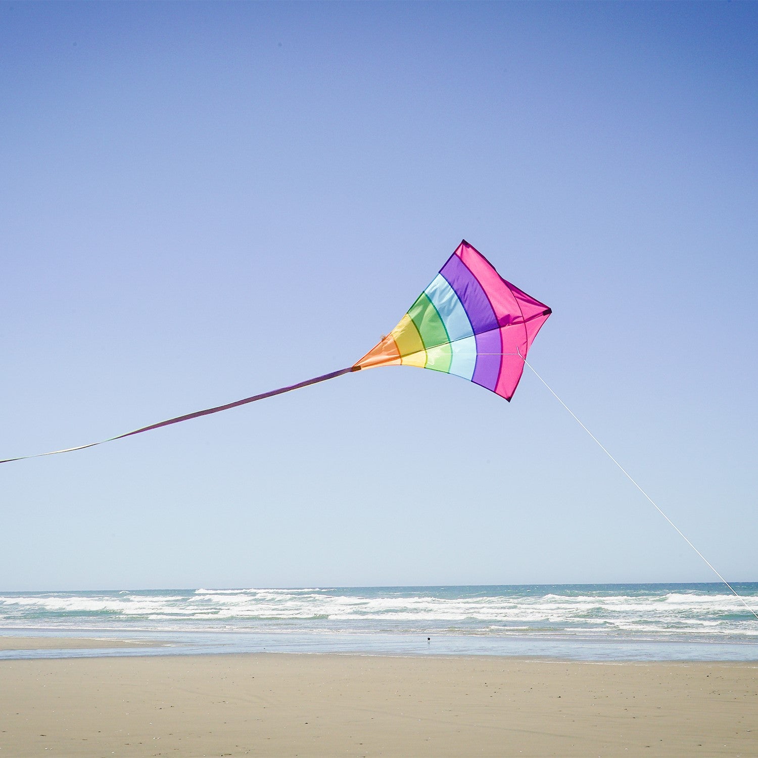 Fiesta Arch 39" Diamond Kite with colorful design flying high against a bright blue sky during outdoor family fun.