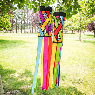 Fiesta Diagonal Weave 60\" Windsock with vibrant colors and black edging, fluttering in an outdoor setting against a bright blue sky.