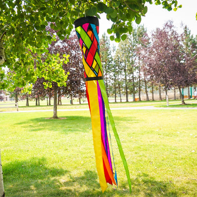 Fiesta Diagonal Weave 40-inch windsock featuring bright colors and black edging, fluttering in the breeze against a clear sky.