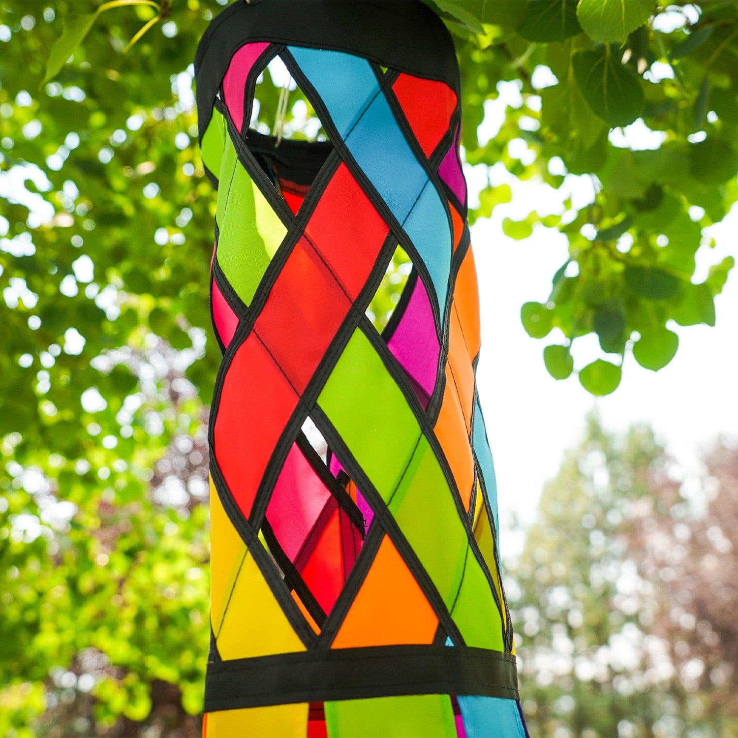 Fiesta Diagonal Weave 40-inch windsock featuring bright colors and black edging, fluttering in the breeze against a clear sky.