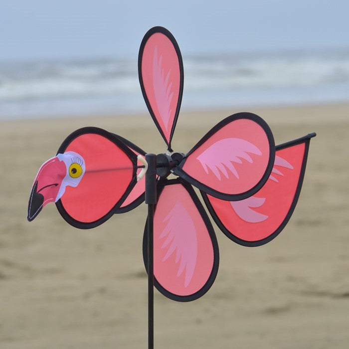 Colorful Flamingo Baby Spinner twirling on a fiberglass pole in a sunny garden, bringing joy and whimsical fun to the outdoor space.