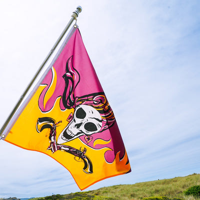 Flintlock Pirette grommet flag with a detailed design of a fierce female pirate displayed outdoors, showcasing vibrant colors and sturdy grommets.