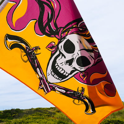 Flintlock Pirette grommet flag with a detailed design of a fierce female pirate displayed outdoors, showcasing vibrant colors and sturdy grommets.