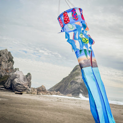 Flip Flops Twistair windsock with eight colorful tails displayed in a sunny garden, featuring whimsical curls that dance in the breeze.