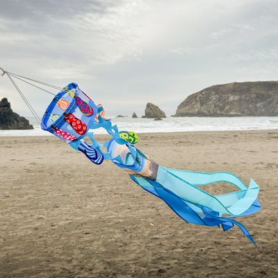 Flip Flops Twistair windsock with eight colorful tails displayed in a sunny garden, featuring whimsical curls that dance in the breeze.