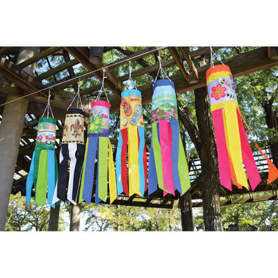 Colorful Flip Flops windsock, showcasing bright pink, blue, and yellow designs, displayed in a garden, swaying gently in the breeze.
