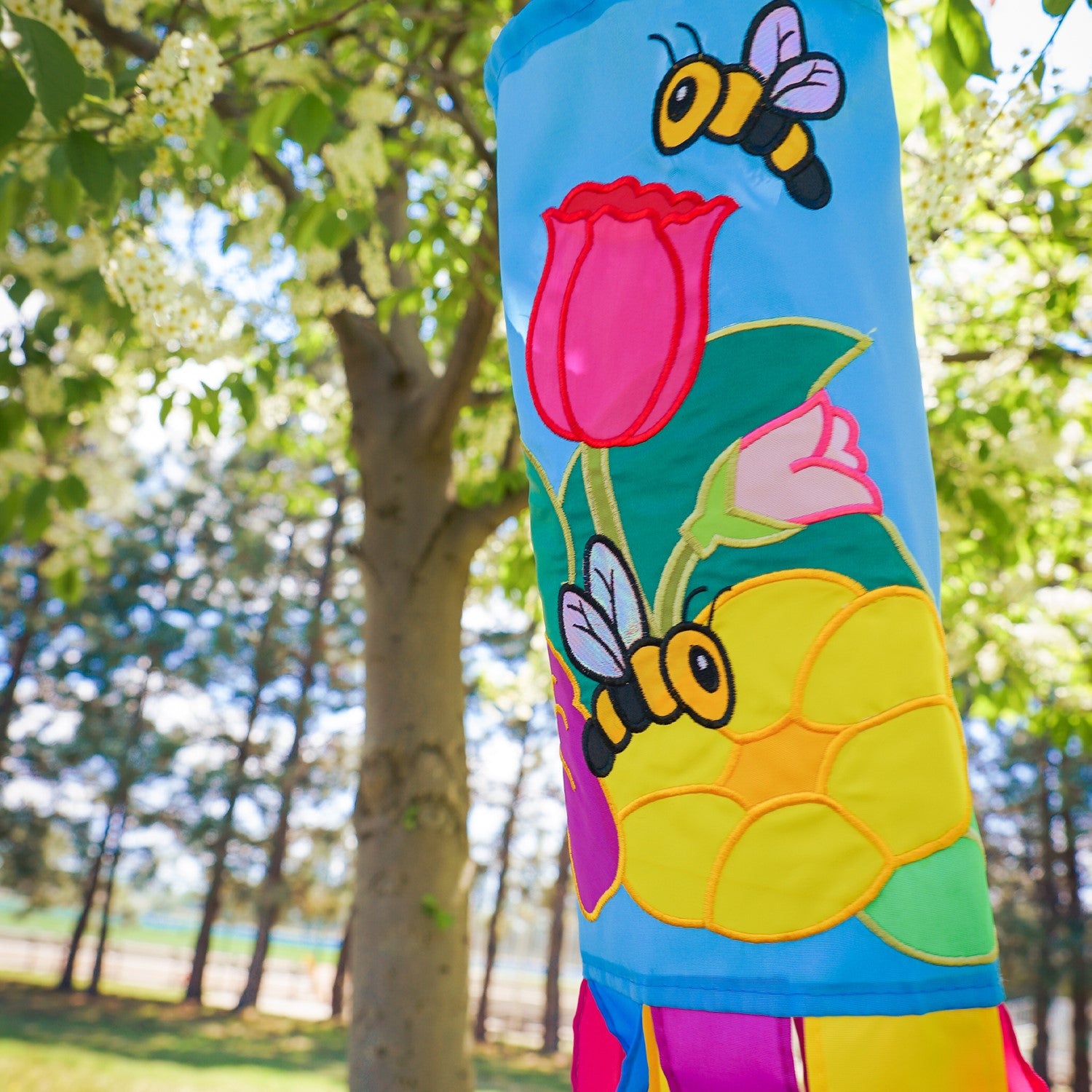 Stunning Floral Bee 40" Windsock with vibrant flower and bee design, fluttering tails, and durable fabric, ideal for enhancing any outdoor space.