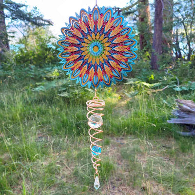 Floral Mandala Mini Set Wind Spinner featuring intricate design and a sparkling crystal twister, displayed outdoors amid greenery.