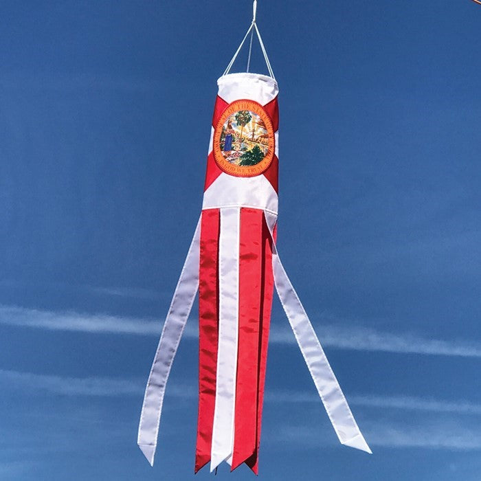 Florida 40-inch windsock displaying the state flag design with bright colors and iconic seal, fluttering outdoors in a scenic garden.