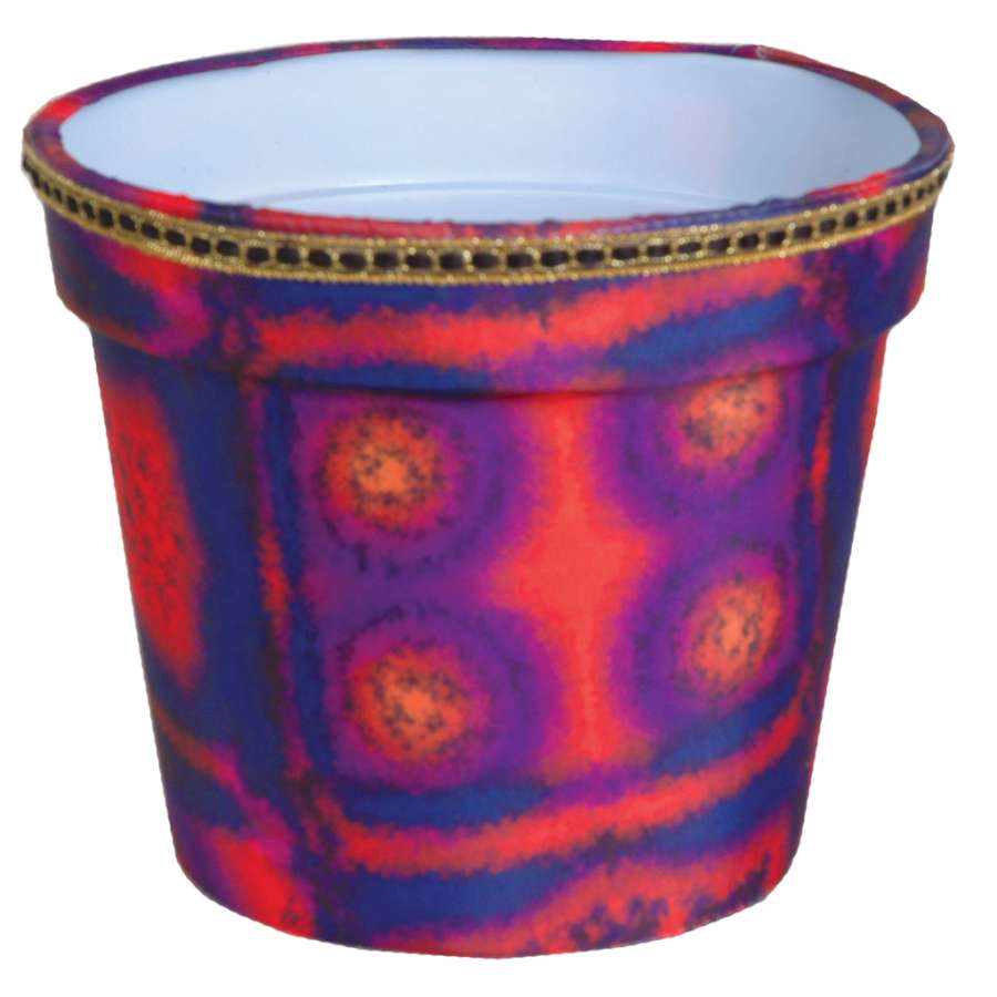 Flower Pot Cover in Aztec Sunrise design, featuring vibrant geometric patterns adorning a standard flower pot in a cozy indoor setting.