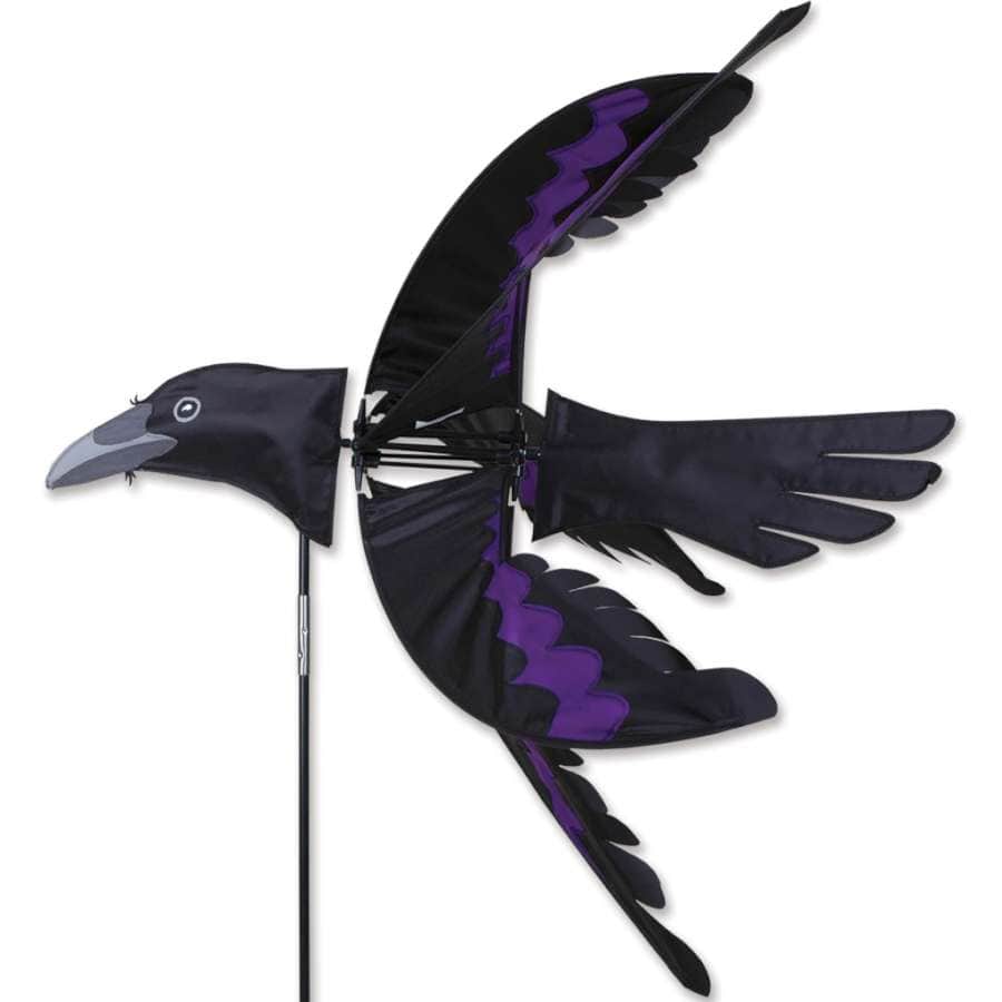 Outdoor bird spinner with bold raven form and wind-powered wings that simulate lifelike flight in vibrant black and purple tones.