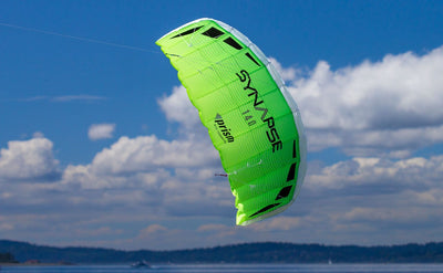 Synapse 140 dual-line stunt kite in Plasma and Cilantro colors with frameless fabric sail, 53-inch wingspan, and complete ready-to-fly line set.