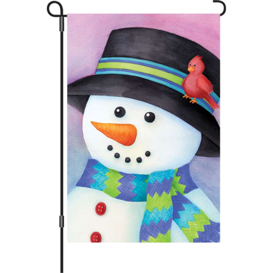 12 in. Friendly Snowman garden flag featuring vibrant colors and cheerful design, displayed outdoors in a winter garden setting.