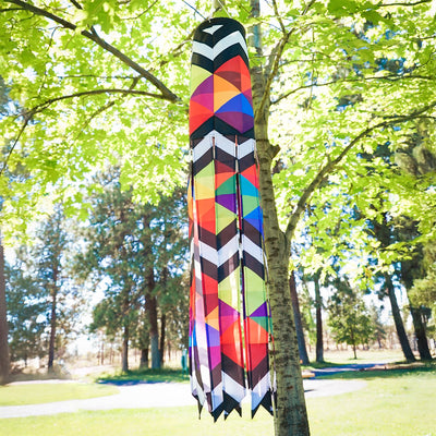 Geometric Black & White 40-inch Illusion Windsock hanging in a garden, featuring embroidered details and stunning printed tails creating a mesmerizing effect.