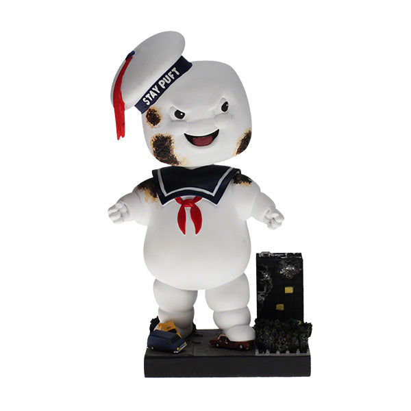 Ghostbusters Classic Stay Puft Scorched Bobblehead standing 8 inches tall on a base designed like a destroyed New York City scene.