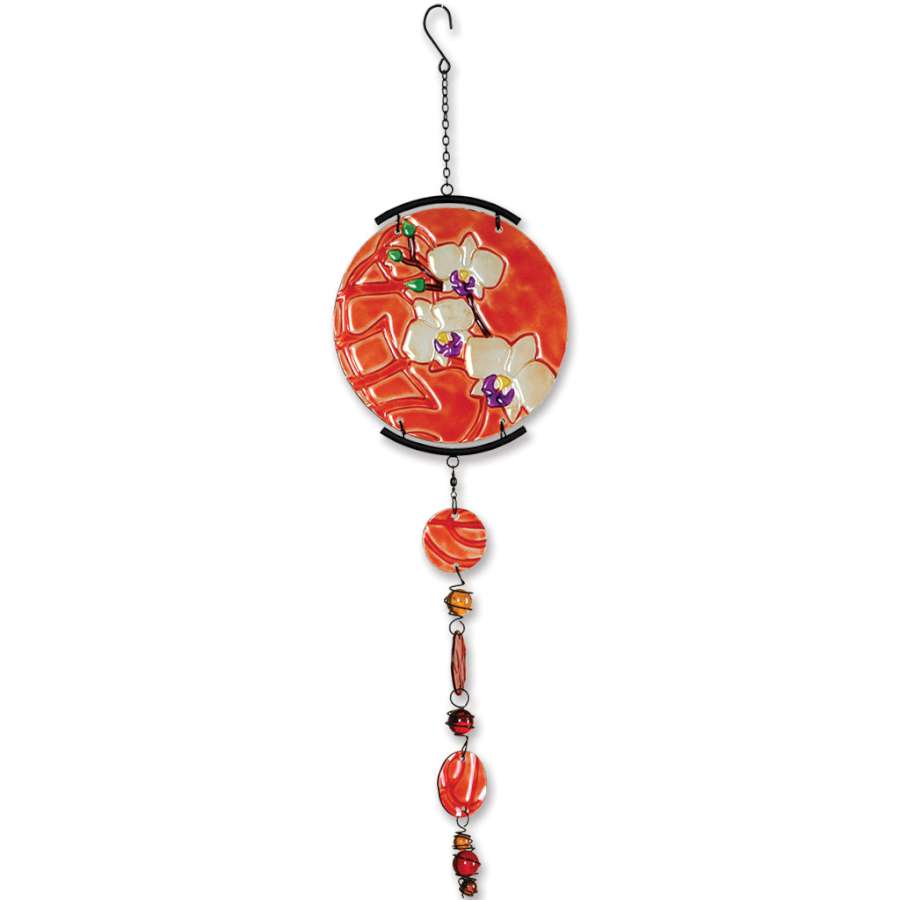 Glass Sun Disk Mobile featuring intricate orchid designs, colors sparkling in sunlight, elegantly suspended against a backdrop of greenery.