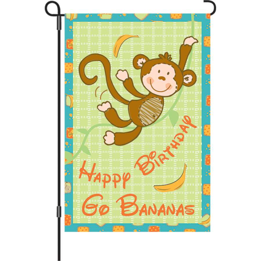 12 in. Go Bananas Monkey garden flag featuring vibrant 'HAPPY BIRTHDAY GO BANANAS' text displayed outdoors in a sunny garden setting.