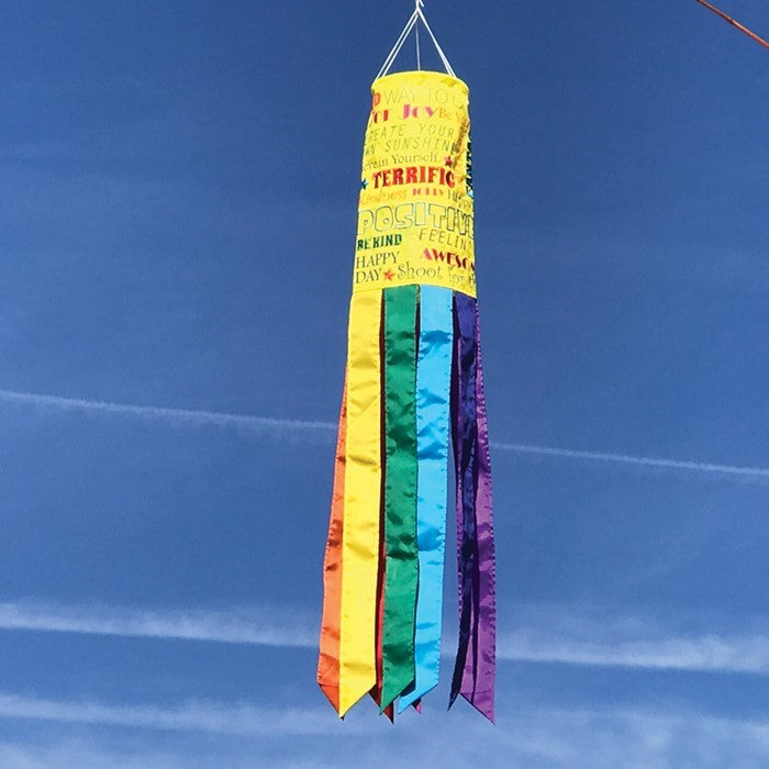Good Vibes Only 40" Windsock with colorful message and fluttering tails displayed outdoors, brightening up the garden scenery.