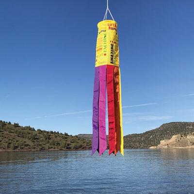 Good Vibes Only 40" Windsock with colorful message and fluttering tails displayed outdoors, brightening up the garden scenery.
