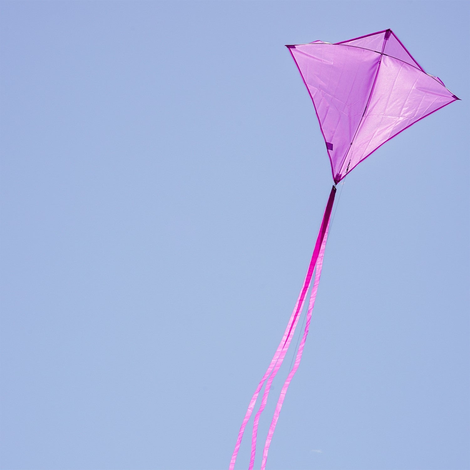 Grape Colorfly 30-inch diamond kite soaring in the sky against a blue backdrop, showcasing its vibrant grape color and stability.