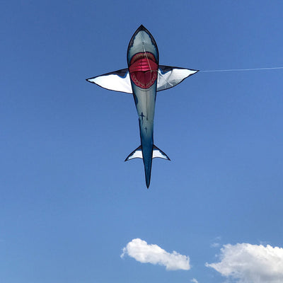 A vibrant 7.5' Great White 3D Shark Kite soaring in a blue sky, showcasing its detailed design and realistic movement, perfect for outdoor fun.