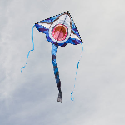 Great White 45' Fly-Hi Kite with a vibrant shark design flying against a blue sky, perfect for outdoor family fun and novice fliers.