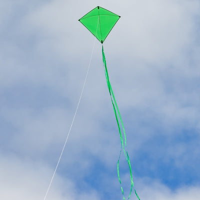 Green Colorfly 30-inch Diamond Kite with three color-coordinated tails soaring against a blue sky, perfect for outdoor family enjoyment.