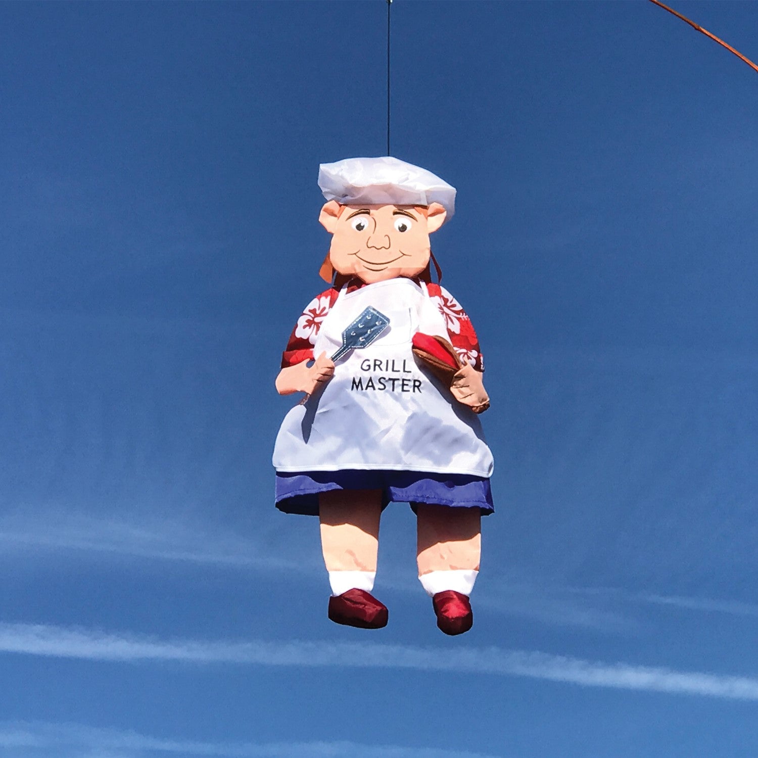 Grillin' Guy Wind Friend whimsical 3D garden decoration featuring a cheerful grill master design, swaying in the breeze on a patio.
