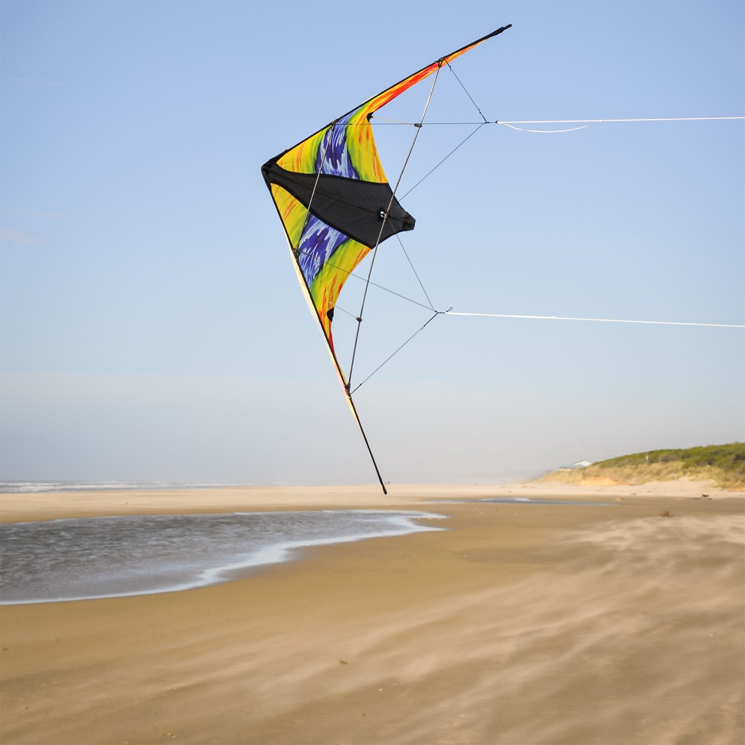 Groovy Stunter 48-inch Sport Kite featuring a colorful colorwave design, soaring against a clear blue sky during outdoor activity.