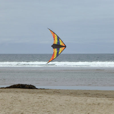 Groovy Stunter 48-inch Sport Kite featuring a colorful colorwave design, soaring against a clear blue sky during outdoor activity.
