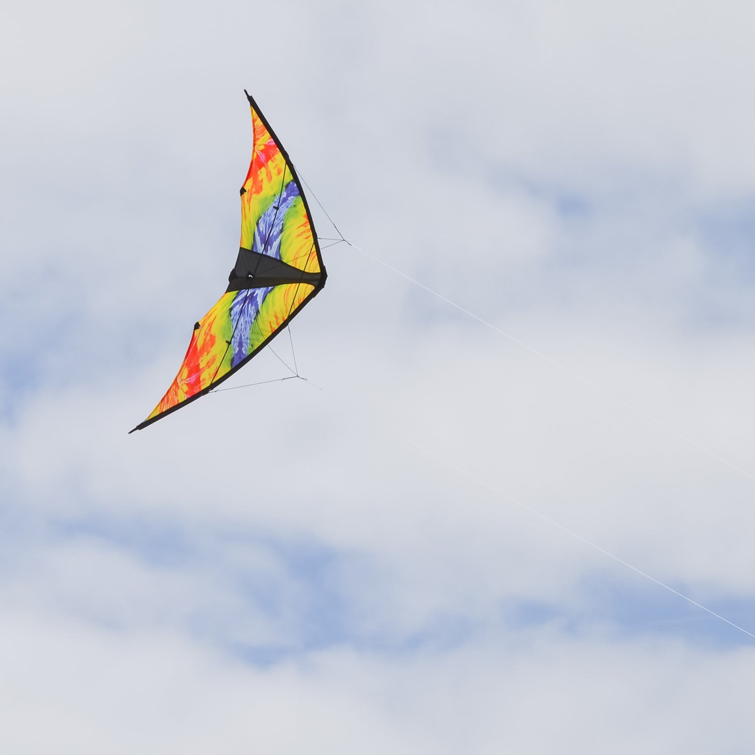 Groovy Stunter 48-inch Sport Kite featuring a colorful colorwave design, soaring against a clear blue sky during outdoor activity.