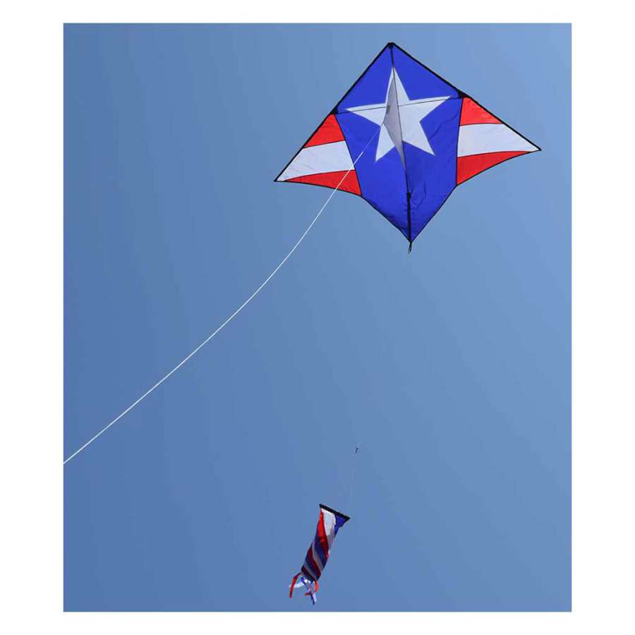Gyro Delta Kite in patriotic colors flying in the sky accompanied by a colorful spinning windsock, measuring 58x44 inches.